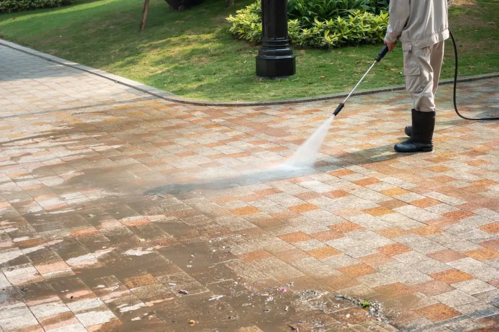 Outdoor floor cleaning with a pressure water jet on street - Packard Power Washing driveways and sidewalk cleaning